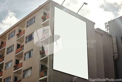 Image of Apartment building, mockup space and advertising billboard, commercial housing and real estate in city. Empty poster for property marketing, branding and communication with announcement in urban area