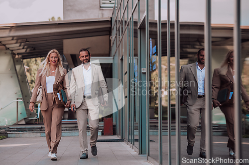 Image of Modern business couple after a long day's work, walking together towards the comfort of their home, embodying the perfect blend of professional success and personal contentment.