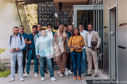 Image of A diverse group of businessmen and colleagues walking together by their workplace, showcasing collaboration and teamwork in the company.