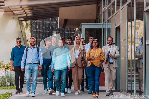 Image of A diverse group of businessmen and colleagues walking together by their workplace, showcasing collaboration and teamwork in the company.