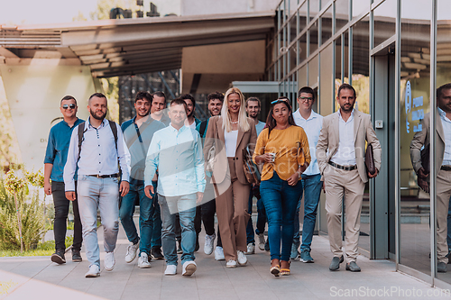 Image of A diverse group of businessmen and colleagues walking together by their workplace, showcasing collaboration and teamwork in the company.