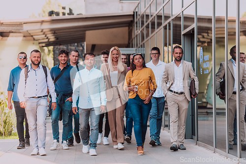 Image of A diverse group of businessmen and colleagues walking together by their workplace, showcasing collaboration and teamwork in the company.