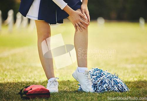 Image of Cheerleader, injury and person with knee pain from sport, training and cheer exercise on a grass field. Health, accident and leg muscle bruise outdoor with emergency or workout challenge for wellness