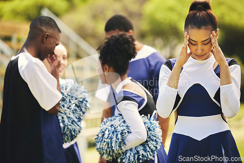 Image of Cheerleader, anxiety and woman headache from sport stress, training and cheer exercise on a grass field. Tired, accident and burnout outdoor with migraine pain and workout challenge for wellness