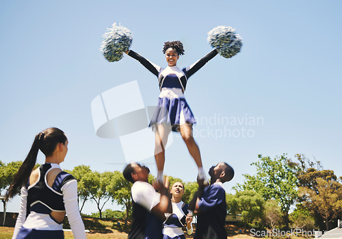 Image of Teamwork, motivation or cheerleader in air with people outdoor in training routine or sports event. Jump, sky or girl by a happy cheer squad group on a field together for support, exercise or fitness