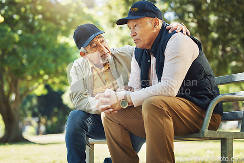 Image of Elderly men, park and comfort with friends, nature and communication with support in retirement. Empathy, closeup and senior people in conversation with trust, together and care on bench in summer