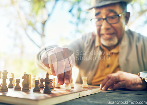 Image of Old man in park, hand with chess game and strategy, competition or challenge, retirement and moving piece. Closeup, planning and contest outdoor, concentration on boardgame and recreation in nature