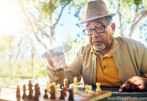 Image of Playing, chess and senior man outdoor with game of strategy and thinking in retirement for mental challenge. Boardgame, choice and elderly person in park, woods or nature and move piece in checkmate