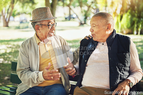 Image of Talking, senior and friends in a park for bonding, communication or together in retirement. Happy, elderly and men speaking with care, smile and enjoying conversation in nature interaction to relax