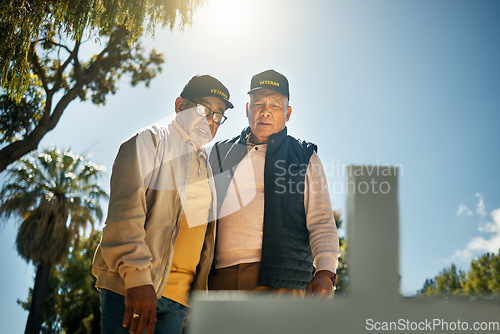 Image of Senior veteran men, tombstone and respect for military, navy or memorial in cemetery for grief, support or empathy. Elderly friends, gravestone and together with thinking, memory and love for soldier