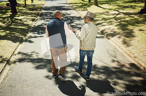 Image of Senior, friends walking and talking in park, nature and outdoor in retirement with support and communication. Elderly, men and behind people on path in New York with conversation and community