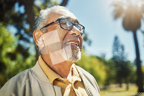 Image of Happy, thinking and senior man in park, nature and outdoor adventure in retirement, holiday or vacation in sunshine. Elderly person, happiness and smile in summer, forest or woods with wellness