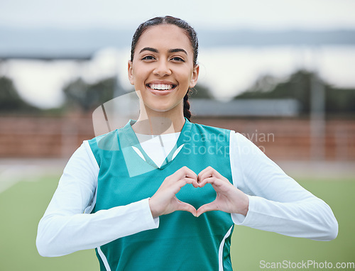 Image of Portrait, heart hands or happy with woman on sports field for fitness, exercise or workout for wellness. Love sign, hand gesture or healthy athlete in training game for hockey or emoji with smile
