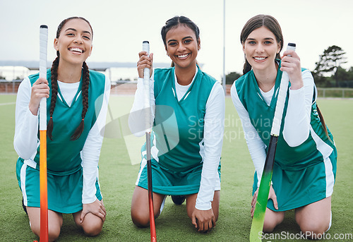 Image of Portrait, smile and hockey with a woman team outdoor on a field for sports, a game or competition together. Fitness, exercise and diversity with a happy young athlete group on an astro turf court