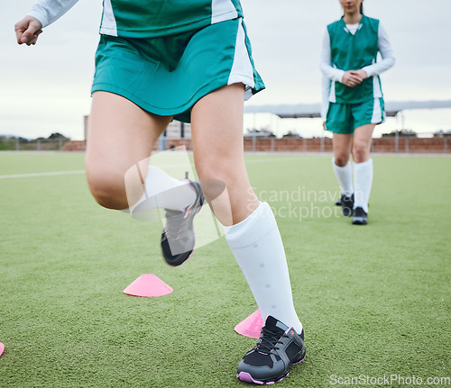 Image of Cone, legs or team running for speed training, workout and warm up exercise on a outdoor hockey turf. Footwear closeup, balance or sports people on grass pitch playing in a practice game for fitness