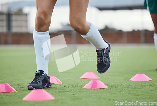 Image of Cone, legs or athlete running in training, workout and warm up exercise on a outdoor hockey field or turf. Closeup, healthy or sports person on grass playing in a practice game for fitness speed