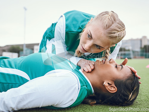 Image of First aid, cpr and breathing with a hockey player on a field to save a player on her team after an accident. Fitness, emergency and heart attack with a woman helping her friend on a field of grass