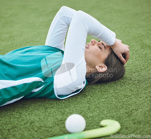 Image of Hockey player, woman is tired in field with fitness and sport, challenge or loss with burnout outdoor. Exercise, wellness and fatigue with fail in competition, mistake and crisis on stadium turf