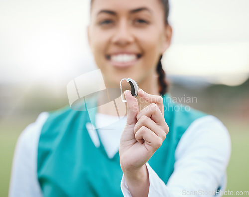 Image of Hearing aid in hand, person with disability and healthcare in sports with medical audio tech for communication. Health, wellness and support, deaf and help with sound waves and athlete with implant