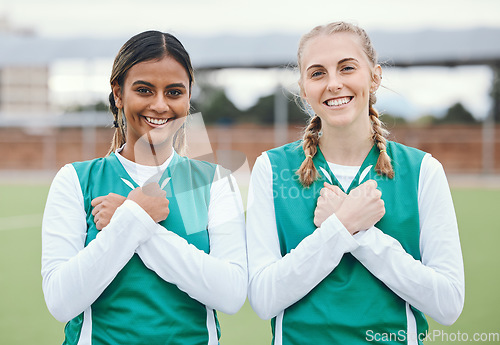 Image of Crossed arms, sports and portrait of friends for hockey on field for training, exercise and workout. Fitness, team and happy women with hand gesture on chest for teamwork, support and bonding in club