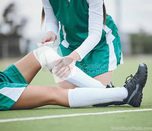 Image of Athlete, knee injury and help on field, sports and accident in sportswear. Person, emergency and first aid for joint pain, bruise and inflammation to bandage, broken by fall and suffering in game