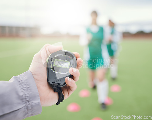 Image of Hands, coach or team with stop watch on field to monitor time, fitness training or exercise progress. Hockey, performance blur or fast sports athlete with timer to check running workout or wellness