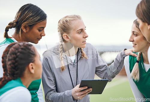 Image of Coach, sports women or team planning tactics or strategy in a hockey training game, conversation or match. Tablet, talking or athletes in practice for fitness exercise together for teamwork in group