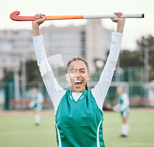 Image of Hockey player in portrait, woman on turf with celebration and smile for fitness and sports win during game. Cheers, happiness and young athlete with stick, success and champion in competition