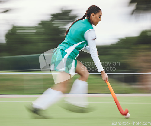 Image of Hockey, speed or woman running in game, tournament or training with ball, stick or action on turf. Blur, sports or fast girl player in exercise, workout or motion on artificial grass for fitness