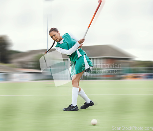Image of Hockey, sports or woman in a training game, tournament or competition with ball, stick or action on turf. Blur, strong or fit girl player in exercise, workout or motion on artificial grass for power