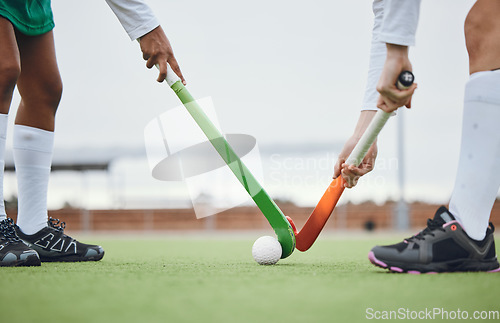 Image of Fitness, hockey and women with sticks and ball on field for training, competition or challenge outdoor. Sports, person and legs on grass with workout, battle or exercise for wellness in nature