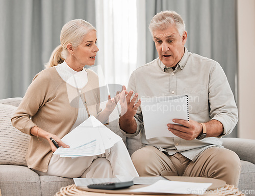 Image of Stress, old couple with documents and taxes in home, mortgage payment and retirement funding crisis. Financial budget, senior man and woman on sofa with anxiety for bills, life insurance and debt.