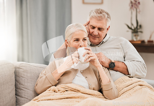 Image of Old couple, hug and relax on couch with coffee, love and support, bonding while at home with trust and comfort. People have tea together, marriage or partner with retirement, calm and peace of mind