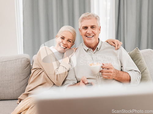 Image of Old people, home and watching tv with coffee and happiness together in retirement with comedy and partner. Love, care and online streaming, funny tv show with tea and couple relax on couch for movie