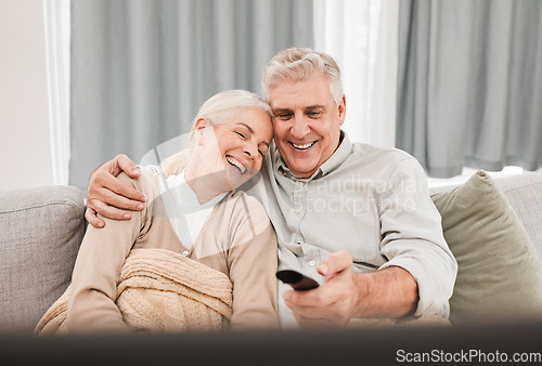 Image of Senior couple, tv and laughing with love on a living room sofa with smile and movie at home. Elderly people, bonding and marriage in retirement with series and streaming in lounge on a couch together