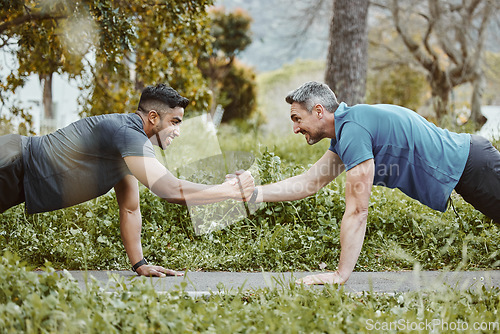 Image of Fitness, nature and men doing push up in team for arm strength or muscle development in park. Sports, workout handshake and male athlete friends do exercise for training together in outdoor garden.