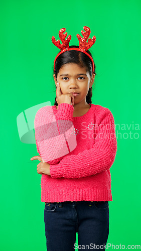 Image of Christmas, thinking and portrait of girl on green screen with arms crossed for idea, thoughts and wondering. Festive, decor and child in studio brainstorming for holiday, celebration and Santa list