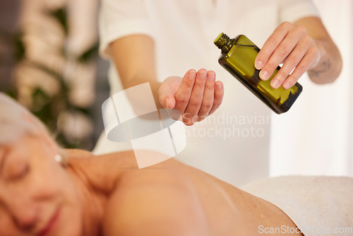 Image of Massage, oil and a therapist with a woman at a spa to relax with wellness and skincare service. Hands, bottle and a masseuse with stress relief treatment for a patient body or person at a hotel