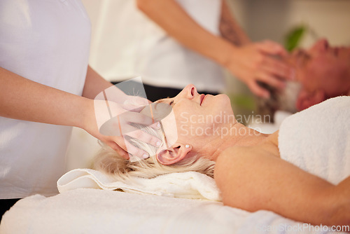 Image of Relax, head massage and senior couple at a spa for health, wellness and anti aging skincare treatment. Calm, beauty and elderly man and woman in retirement with wrinkles face routine at natural salon