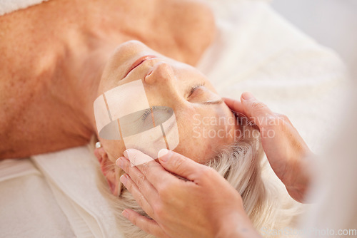 Image of Spa, head massage and senior woman at a spa for luxury, self care and facial healing treatment. Relax, wellness and elderly female person on a retirement retreat for face therapy at natural salon.