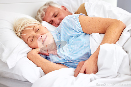 Image of Sleeping, bedroom and senior couple with love, relax and retirement on a weekend break, resting and calm. Peace, old woman or elderly man in a bed, home or morning with care, marriage or relationship