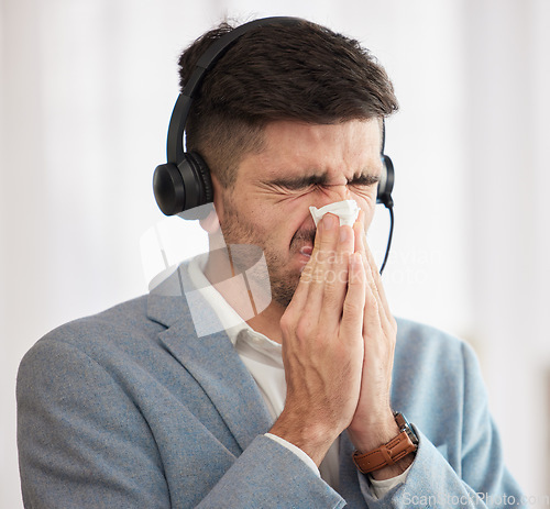 Image of Customer service, sick or man blowing nose in call center office with hay fever sneezing or illness. Cold, contact us or sales agent with toilet paper tissue, allergy virus or flu disease at work