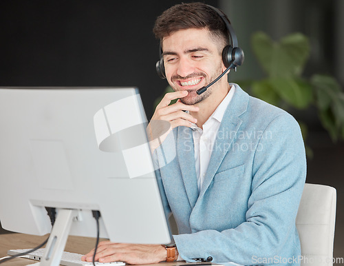 Image of Man, headset and smile while looking at screen in office, talking and customer care for telemarketing. Person, consultant or operator with technology for business, e commerce or management of clients