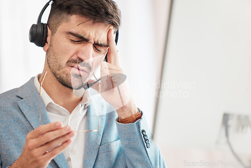 Image of Call center stress, anxiety or man with headache pain from burnout fatigue in a telecom company job. Migraine, failure crisis or tired consultant depressed or frustrated by crm or sales job deadline