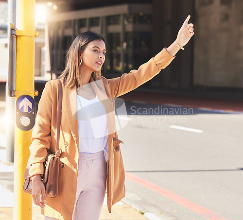 Image of Wave, taxi and woman in city for cab, transportation and commute travel in cbd for business or meeting. Person, hand and sign to call attention of taxicab driver and passenger service in town