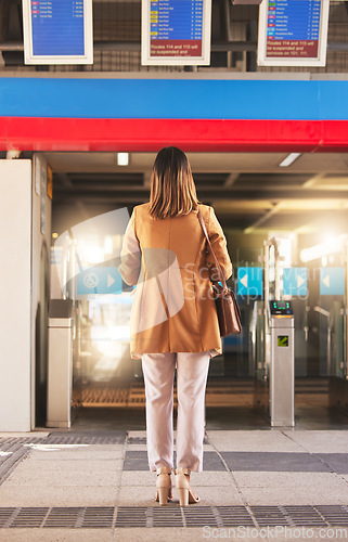 Image of Walking, back and a woman at a station for a train, travel and entrance at a platform. Standing, waiting and a person entering a subway or gate for transportation, public traveling or transit