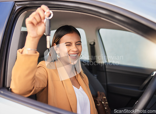 Image of Portrait, car and woman with a key, smile and celebration with achievement, goals and success. Face, wink and happy girl with transportation, commute and new vehicle with travel, safety and road trip