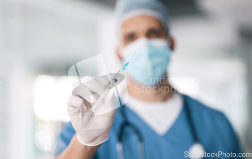 Image of Man, doctor and hand with needle for vaccine, injection or antibiotic for healthcare or medical cure at hospital. Closeup of male person, nurse or surgeon with mask, gloves and flu shot at clinic