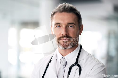 Image of Mature doctor, portrait and man in hospital for healthcare, wellness and career in clinic. Face, medical professional and confident expert surgeon, therapist worker and senior employee in Canada.