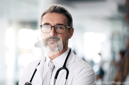 Image of Serious doctor, portrait and man with glasses in hospital for health, wellness or career in medicine. Face, medical professional and confident surgeon, expert therapist or mature physician in Canada